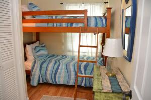 a bedroom with two bunk beds and a bed at Little Miss Cottages - 68 East Grand Luxury Condo in Old Orchard Beach