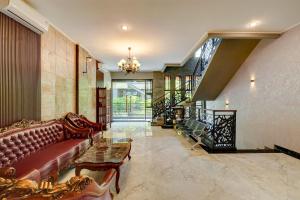 un salon avec un canapé et un lustre dans l'établissement YASA Residence Fatmawati, à Jakarta
