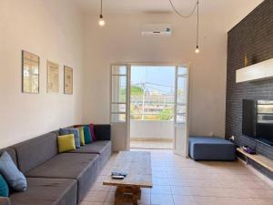 a living room with a couch and a fireplace at Lester 4-Bedroom Apartment in Mar Mikhael in Al Mudawwar