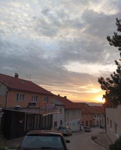 a car parked in a street with a sunset in the background at Apartman Dream in Livno