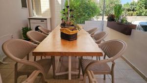 a table with chairs and a potted plant on a balcony at Casa Katerini Bright 3BR with Balcony in Chania Town