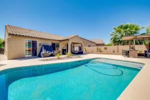a swimming pool in front of a house at San Tan Valley Vacation Rental with Community Perks! in San Tan Valley