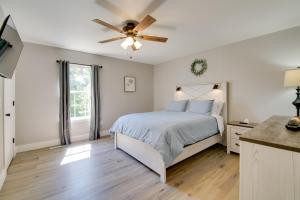 a bedroom with a bed and a ceiling fan at Kimberling City Getaway Fish and Boat Nearby! in Kimberling City