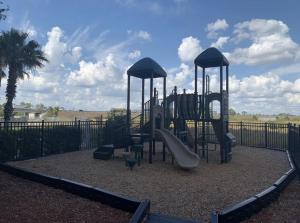 a playground with a slide in a park at Resort Lake Buena Vista - 2 Quartos in Vineland