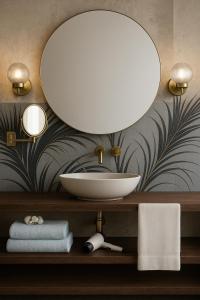 a bathroom with a bowl sink and a mirror at NEW TOWN Boutique Apartments & Parking in Graz