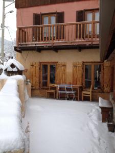 a house with a snow covered yard in front of it at Studio Serre Chevalier Briancon in Briançon