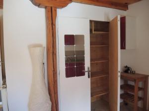 a room with a door and a closet with shelves at Studio Serre Chevalier Briancon in Briançon +5 photos