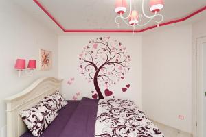 スームィにあるApartament loft Centerの壁にハートのついた木がある寝室