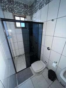 a bathroom with a toilet and a shower and a sink at Acomodação Bela Vista in Mariana +19 photos