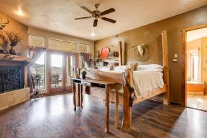 een slaapkamer met een bed en een plafondventilator bij Mtn-View Adobe Home with Large Deck Near Prescott! in Humboldt