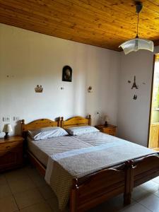 a bedroom with a wooden bed and a wooden ceiling at Appennino nord in Alfero +4 photos