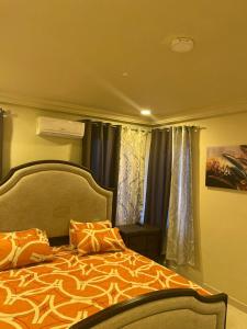a bedroom with a bed and a window with curtains at W&J Luxury Home Plaza in Trofwi