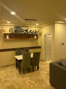 a living room with a table and chairs and a couch at W&J Luxury Home Plaza in Trofwi