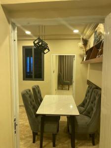 a dining room with a table and two chairs at W&J Luxury Home Plaza in Trofwi +16 photos