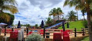 a group of chairs and umbrellas next to a pool at Eco Park Campo Grande Hotel in Campo Grande