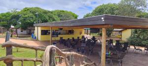 a yellow building with tables and chairs in front of it at Eco Park Campo Grande Hotel in Campo Grande +19 photos