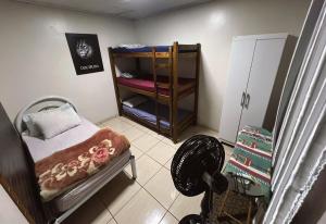 a small room with a small bed and a closet at Pousada Locks, Cascavel, Paraná - 02 in Cascavel
