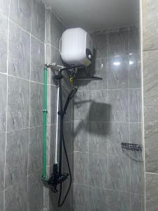 a shower in a bathroom with a shower head on a wall at Mercy Apartment in Ikeja +42 photos