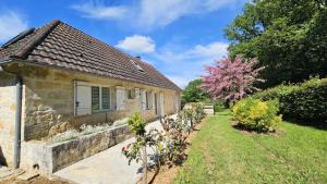 an old stone house with a garden in front of it at Gîte de France Les jeunes années 3 épis - Gîte de France 6 personnes MAE-3553 in Turenne