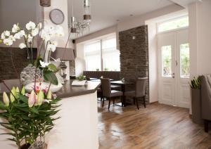 a kitchen and dining room with a table and chairs at Hotel Ravene in Cochem