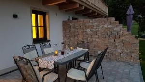 a dining table and chairs on a patio at Entspannung auf dem Land in Dietramszell