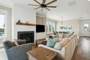 a living room with couches and a fireplace at 207 E Arctic - Seahorsing Around - Oceanfront - 3 Bedrooms in Folly Beach