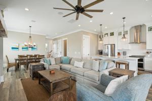 a living room with a couch and a table at 207 E Arctic - Seahorsing Around - Oceanfront - 3 Bedrooms in Folly Beach