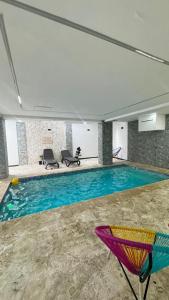 a large swimming pool in a large building with at Apartmet luxury monaco in Juan López +13 photos