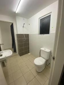 a bathroom with a toilet and a sink and a shower at Homestay TigaCahaya in Seremban +35 photos
