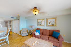 a living room with a couch and a table at Four Winds 902 in Orange Beach