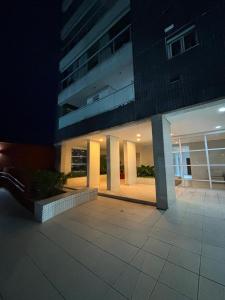 a large building at night with a sidewalk in front of it at TORRE SOLAZZO - Cop 30 in Belém