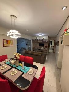 a living room with a table and red chairs at TORRE SOLAZZO - Cop 30 in Belém