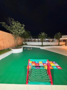 a goal in the middle of a green soccer field at TORRE SOLAZZO - Cop 30 in Belém +8 photos