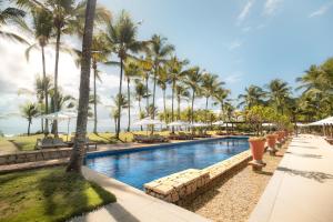 una piscina en el resort con palmeras en Txai Resort, en Itacaré