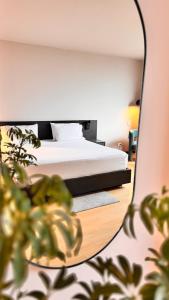 a bedroom with a bed and a mirror at Tequendama Hotel Medellín - Estadio in Medellín