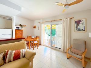 a living room with a couch and a dining room at Ca L'Anxoveta - casa amb piscina a prop de la platja a l'escala in L'Escala