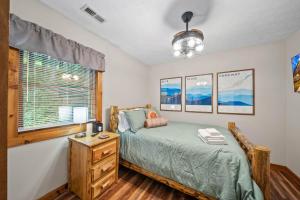 Un dormitorio con una cama y una ventana y una mesa. en The Smore the Bearier, en Zionville