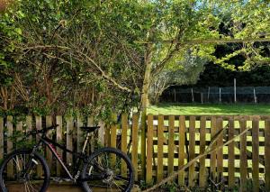 a bike parked next to a wooden fence at Bed in mixed room of 3 to 4 or private room for 3 to 4 in Zizur Mayor