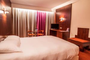 Postel nebo postele na pokoji v ubytování Hotel des Congrès