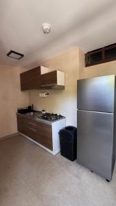 a kitchen with a stainless steel refrigerator and a stove at Casa Belmur in Mazatlán