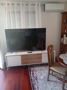 a large flat screen tv sitting on a entertainment center at Apartman Travnik in Travnik
