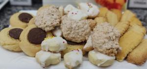 a plate of cookies and pastries on a table at Hotel Gran Fenícia Marechal in Marechal Cândido Rondon