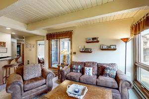 a living room with two couches and a table at The Lodge at Steamboat in Steamboat Springs