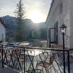 a balcony with chairs and a view of a mountain at La Chicholiere in Gresse-en-Vercors