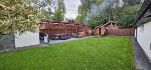 a backyard with a grill and a gazebo at Sielskie Sitno in Sitno
