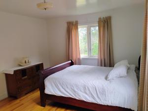 a bedroom with a bed and a window at 6 Olivia Lane in Deer Lake