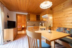 a kitchen and dining room with a wooden ceiling at Haus Hubertus in Schruns-Tschagguns