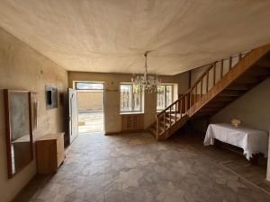 a large room with a staircase and a table in it at Family cozy House in Berd in Berd