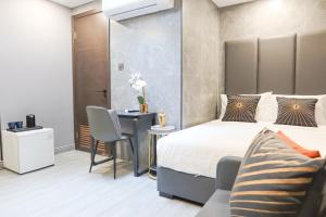a bedroom with a bed and a table and chairs at Comfy 2 Bedroom Apartment by ReCharge in Singapore
