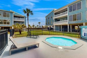 a patio with a swimming pool and a building at Sea Oats A203 in Gulf Shores
